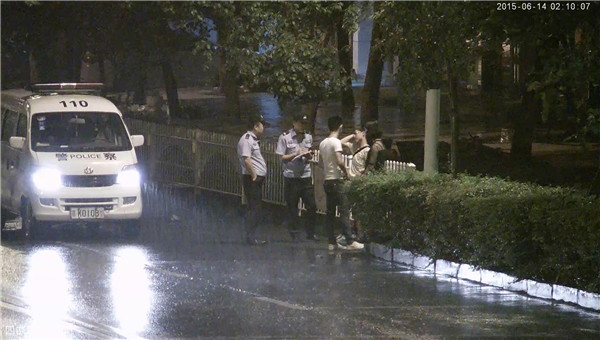 民警雨中對(duì)戴眼鏡、白T恤男及女孩進(jìn)行盤查.jpg